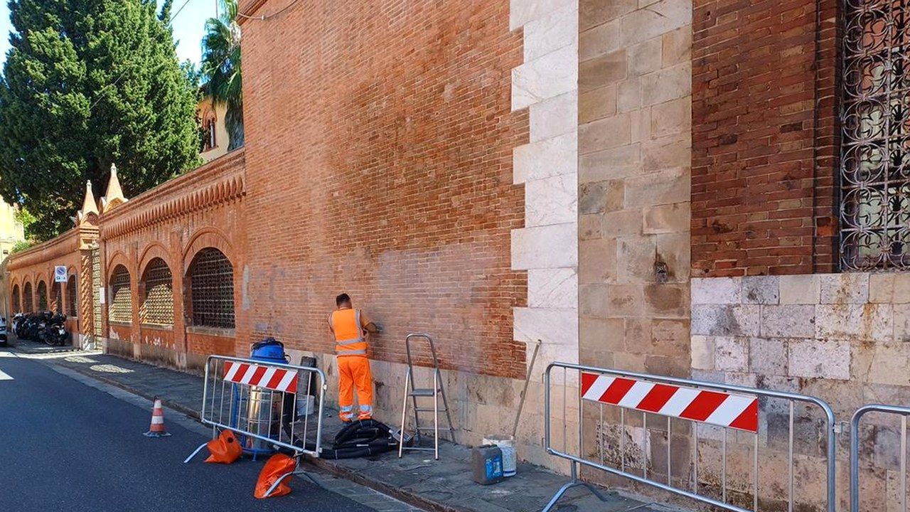 Pisa, operaio al lavoro per rimuovere le scritte dai muri di un palazzo storico del centro dopo il corteo per Fakir